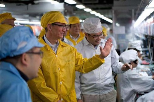 Handout photo shows Apple CEO Cook talking to employees as he visits the iPhone production line at the new Foxconn Zhengzhou Technology Park in Henan