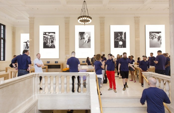 Apple employees gather in the company's new store, Thursday, June 11, 2015, on New York's Upper East Side. The new store, scheduled to open Saturday, occupies part of a Beaux Arts building that originally housed the U.S. Mortgage & Trust bank. Apple sought to restore some of the building’s old grandeur by reproducing the original chandeliers seen in old photographs, restoring marble floors and pilasters and turning a bank vault into a VIP showroom. (AP Photo/Mark Lennihan)
