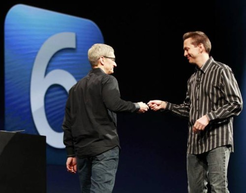 Scott Forstall, senior vice president of iOS Software at Apple Inc. (R), hands off the remote to Apple CEO Tim Cook during the Apple Worldwide Developers Conference 2012  in San Francisco