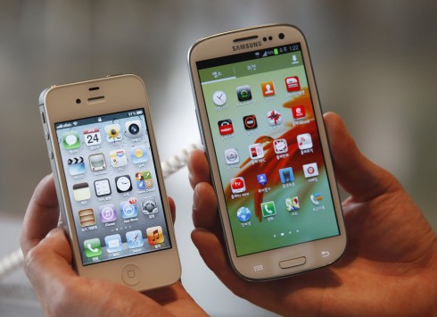 An Apple iPhone 4Ss and a Samsung Galaxy S III are displayed in Seoul