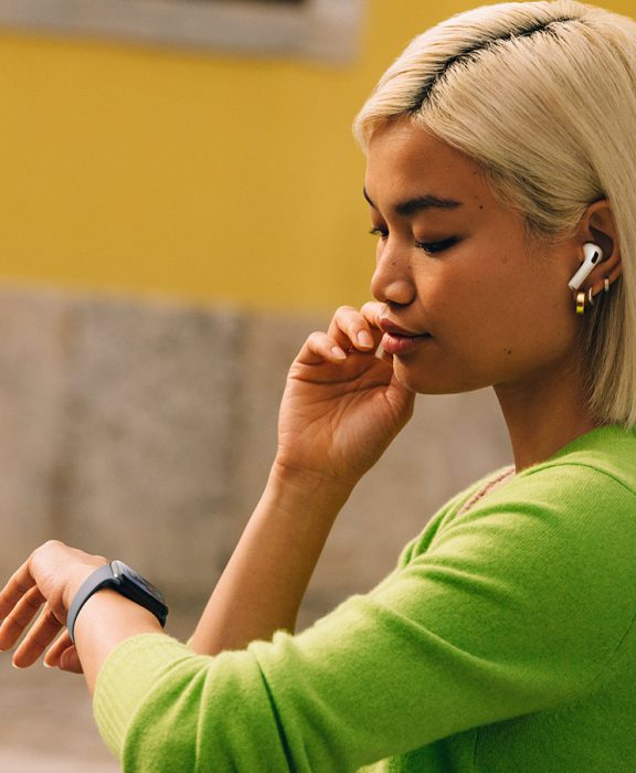 Egy nő az Apple Watch-ára néz.
